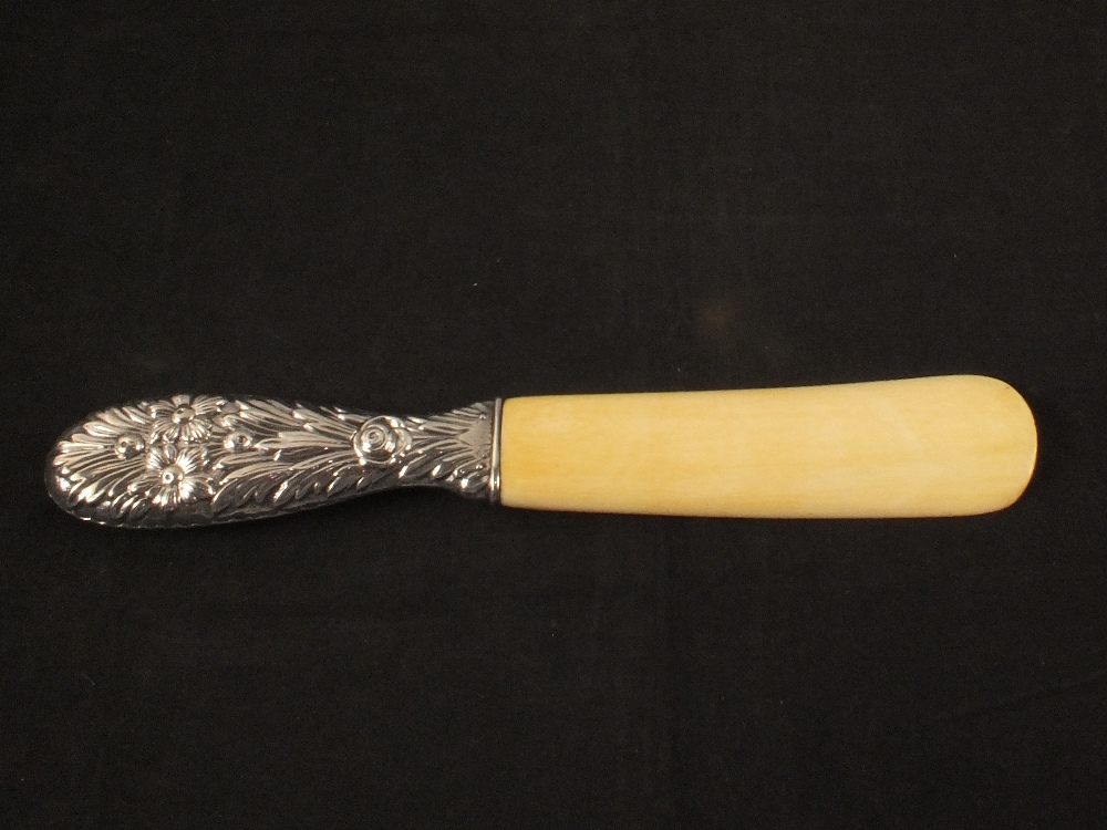 A silver handled ivory shoe horn