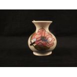 A small Moorcroft Magnolia pattern vase on white ground,