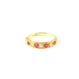 An 18ct gold diamond and red stone set half eternity ring,