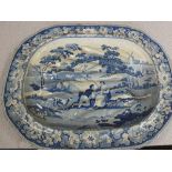 A Victorian blue and white well and tree meat plate with shepherd and shepherdess decoration (light