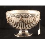 A silver plated punch bowl with swags of grapes on a fretted frame and opaque glass liner,