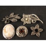 A group of five silver brooches including a Scottish agate brooch