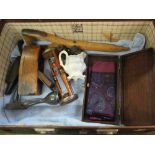 A suitcase containing an hourglass, opera glasses,