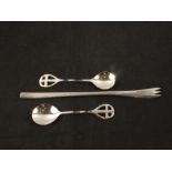 A pair of Keswick School of Industrial Art silver teaspoons with twisted stems and stylised cross
