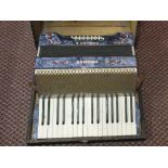 A cased Hohner Carmen II piano accordion