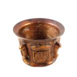 A heavy 16th/17th Century continental bronze mortar with four raised Coats of Arms divided by