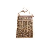 A pierced brass card case with ornate floral decoration