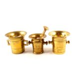 Three heavy 18th Century twin handled brass mortars, one with pestle,