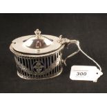 An oval silver mustard with pierced and engraved decoration, Nathan & Hayes,
