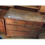 A late Georgian oak chest of two short and two long drawers on bracket feet with brass handles