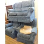 A blue floral upholstered two seater sofa and two matching armchairs