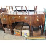 A Regency style sideboard with central drawer flanked by two cupboards on square tapered legs