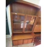 A Nathan teak glazed bookcase with two door cupboard base below