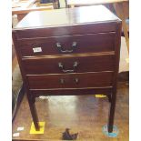 An Edwardian three drawer music cabinet with matching two drawer piano stool