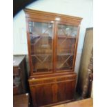 A reproduction yew astral glazed cupboard bookcase