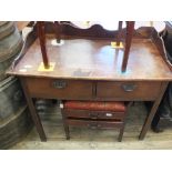 A mahogany two drawer writing table with shaped gallery (as found)