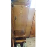 A 1930's oak single door wardrobe,