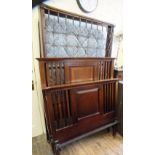 An Edwardian bed head board and end with sprung base and mattress and bears label for Staples