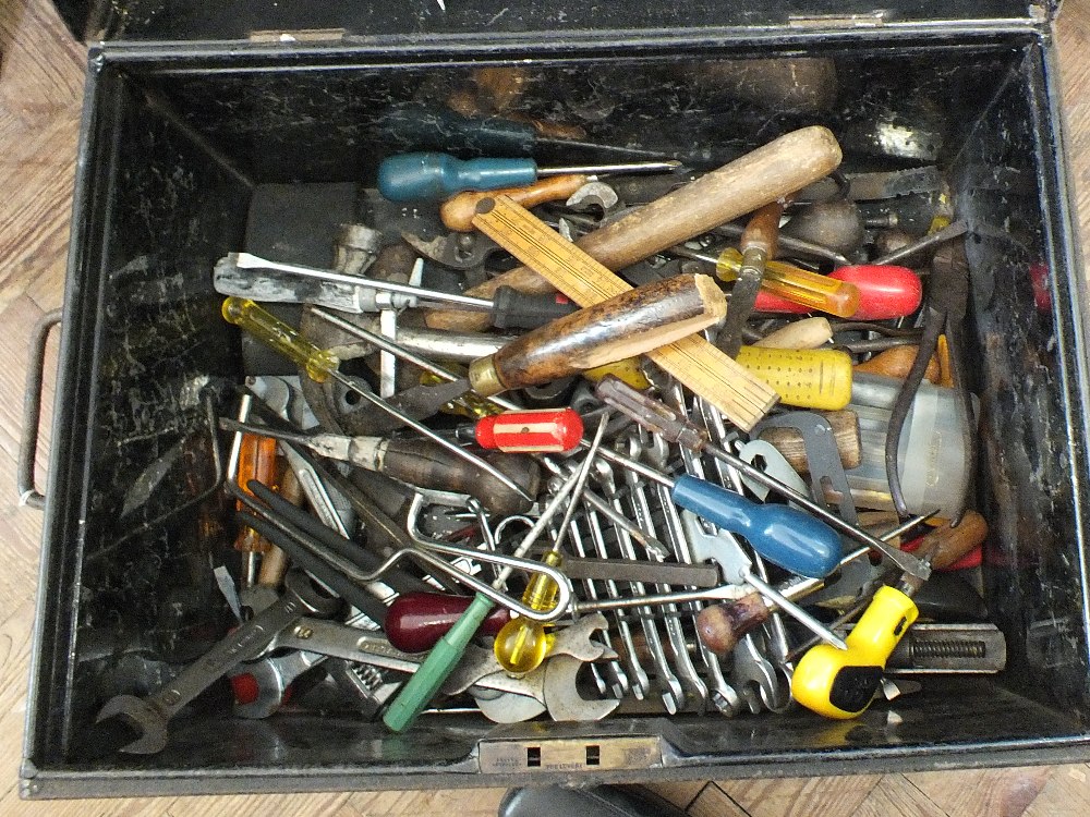 A small tin trunk containing a wide variety of tools