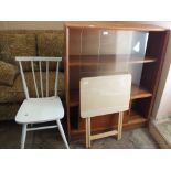 A modern glazed bookcase with cupboard below,