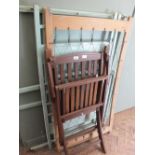 A blue painted wooden cot and a folding garden chair