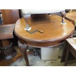 An oval extending mahogany dining table with one extra leaf on ball and claw legs,