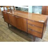 A long teak 1970's style sideboard, with three door cupboards and three drawers,