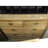 A Victorian stripped oak chest of two short and three long drawers with brass handles