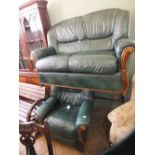 A dark green leather settee with matching electric reclining armchair