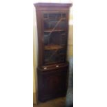 A reproduction glazed corner cupboard