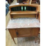 An Edwardian rouge marble top washstand with towel rail and tiled shelf back