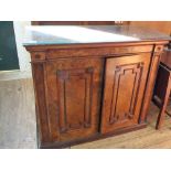 A 19th Century burr walnut two door cupboard with carved embelishment