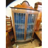 A mahogany and lead glazed bow fronted inlaid display cabinet