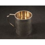 A silver tankard with engine turned banding,