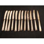 Eleven silver handled knives plus a silver knife with mother of pearl handle (most as found)