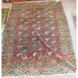 A Persian rug with repeating central medallions,