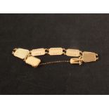 A 9ct gold flat rectangular link bracelet with engraved backs,