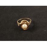 A yellow metal ring set with single pearl, stamped '585',