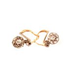 A pair of unmarked gold diamond cluster earrings