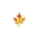 A 14ct gold maple leaf brooch with enamel seed pearl decoration to front (some pearls missing)