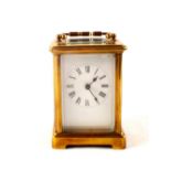 A brass carriage clock with enamel dial (light glass chip)