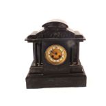 A black marble striking mantel clock