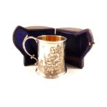 A cased silver christening mug with chased decoration of girls with dog and feeding birds with
