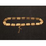 A 9ct gold with eighteen flat rectangular link bracelet with engraved backs