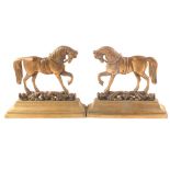 A pair of brass horse door stops