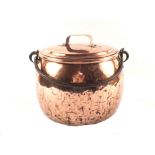An antique bulbous seamed copper cauldron with lid and iron swing handle,