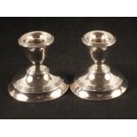 A pair of silver squat candlesticks,