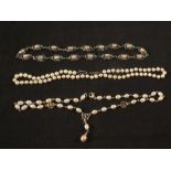 Two cultured pearl necklaces with silver clasps together with an unusual white metal necklace set