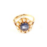 A 9ct gold cluster ring with light blue stone surrounded by small pearls,