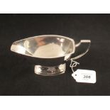 A silver sauce boat on tapered foot, Birmingham 1937,